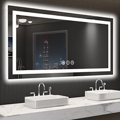 a bathroom with two sinks and a large mirror over it's counter top that is illuminated by lights