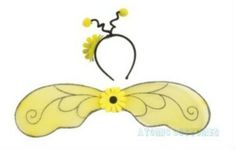 a yellow butterfly with wings and flowers on it's back