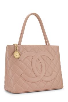 Find CHANEL Quilted Caviar Tote on Editorialist. This Chanel tote bag features quilted caviar leather with a gold tone logo, top handles, and a medallion charm. The bag also has a push lock closure. Gold Quilted Bag For Everyday Luxury, Gold Quilted Top Handle Bag, Luxury Gold Quilted Bag, Luxury Quilted Gold Bag, Luxury Quilted Double Handle Bag, Luxury Double Handle Shoulder Bag With Gold-tone Logo Plaque, Chic Travel Bag With Logo Charm, Designer Gold Bag With Logo Charm, Elegant Gold Bag With Logo Charm