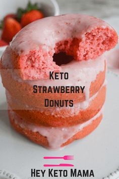 a close up of a doughnut on a plate with the words keto strawberry donuts