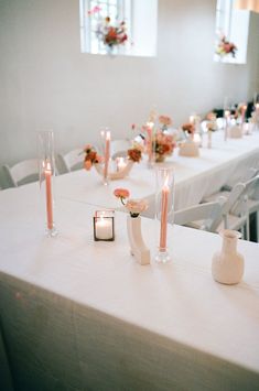 the table is set with candles and vases