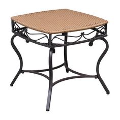 an outdoor table with wicker top and iron frame legs, isolated against a white background