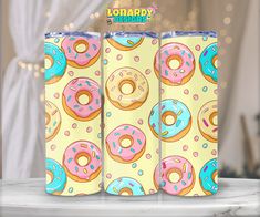 three colorful donuts on a yellow background with the words happy birthday written above them