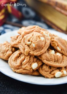 a white plate topped with cookies and marshmallows on top of a table