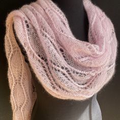 a close up of a mannequin wearing a pink scarf with lace on it