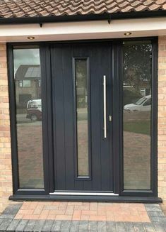 a black double door with sidelights and glass