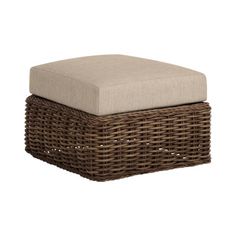 a wicker ottoman with a cushion on top