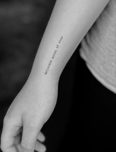 a woman's arm with a small tattoo on it that says, i love you