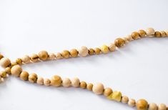 a wooden bead necklace is shown on a white surface