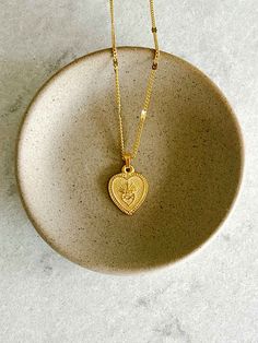 Share your love of the Sacred Heart of Jesus with our Heart Shaped Sacred Heart Necklace. Featuring a vintage style chain with an image of the Sacred Heart. Makes a lovely gift for Confirmations or First Holy Communions.  18" vintage style chain 14k gold ox over brass This piece is designed and made by Amano Studio, a Vintage Heart Necklace For Mother's Day, Vintage Personalized Gold Plated Necklace, Personalized Vintage Gold Plated Necklace, Personalized Vintage Gold-plated Necklace, Vintage Personalized Heart Necklace, Vintage Gold Heart Pendant Necklace, Vintage Gold Heart Charm Necklace, Vintage Necklaces For Mother's Day, Vintage Necklace For Mother's Day