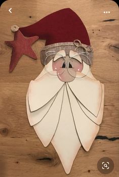 a paper cut out of santa claus with a red hat and star on the side