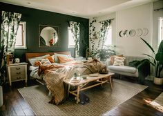 a bed room with a neatly made bed and lots of plants on the wall next to it