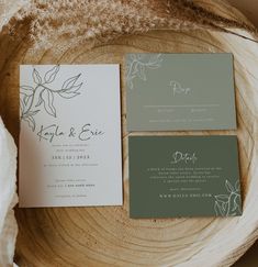 the wedding stationery is laid out on a tree stump