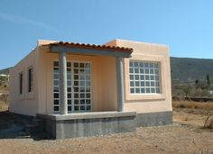 a small house sitting on top of a dry grass field