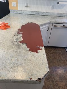 a kitchen counter that has been stripped off with red paint on the top and bottom