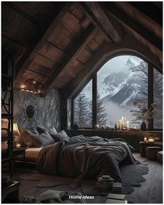 a bed sitting under a window next to a wooden floor covered in pillows and blankets