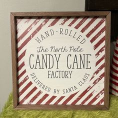 there is a sign that says hand - rolled the north pole candy cane factory