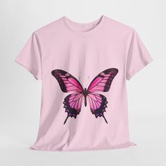 Transform your wardrobe with our stunning Pink Butterfly T-Shirt! This stylish and comfortable tee features a vibrant, oversized pink butterfly graphic that adds a touch of whimsy and elegance to any outfit. Crafted from high-quality, breathable cotton, this shirt ensures all-day comfort and durability. Perfect for casual outings, relaxed weekends, or as a unique statement piece, this t-shirt pairs effortlessly with jeans, shorts, or skirts. Embrace the beauty of nature and let your style soar with our Pink Butterfly T-Shirt. The Gildan 5100P Heavy Cotton™ tee brings incredible style and ecologic sensibility to the table. Made with 100% cotton (fiber content may vary for different colors), each tee offers top-tier softness to the touch. Meanwhile, the classic width and rib collar add a nic Summer Cotton T-shirt With Butterfly Sleeves, Trendy Pink Butterfly Print Tops, Pink Printed Short Sleeve T-shirt, Short Sleeve Graphic Tee With Butterfly Print, Pretty Mom, Short Sleeve Butterfly Print Graphic Tee, Relaxed Fit Butterfly Print Graphic Tee, Cute Butterfly Print T-shirt For Summer, Trendy Short Sleeve T-shirt With Butterfly Print