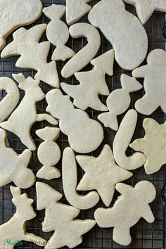 some cut out cookies are on a cooling rack and ready to be baked in the oven