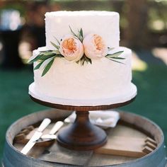 a white wedding cake with flowers on top