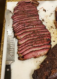 a knife and some meat on a cutting board