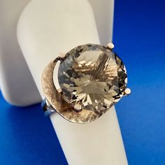 * Gorgeous 14k Yellow Gold Large Smoky Quartz Free Form Statement Ring Size 7.25 * Metal: 14k Yellow Gold * Stone(s): (1) Smoky Quartz * Quartz round measures approximately 15.6 mm * Ring Size: 7.25 * Top of Ring Measurements: 3/4" x 3/4" x 1/2" * Length:1 1/4" * Weight: 7.1 tgw * Markings: 14k * Condition: As pictured.  * G2110 4% Restocking Fee    Exported By ExportYourStore :) Modern 14k White Gold Round Jewelry, Modern Silver Jewelry Stamped 14k, Modern 14k White Gold Jewelry As Gift, Modern 14k White Gold Jewelry For Anniversary, Modern Round Collectible Jewelry, Modern 14k Stamped Formal Jewelry, Modern 14k Gold Collectible Jewelry, 14k Stamped Platinum Gold Jewelry, Modern 14k White Gold Jewelry With Polished Finish