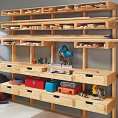 a workbench with many drawers and tools on the shelves in front of it