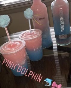 pink and blue drinks are sitting on a table