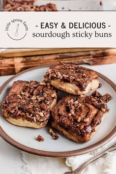 three chocolate covered doughnuts sitting on top of a white plate