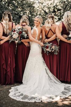 a bride and her bridals in burgundy dresses