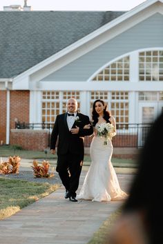 a bride and groom walking down the aisle at their wedding ceremony in front of a church