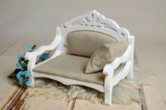 a miniature chair with a pillow on top of it