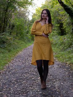 Mustard Tunic dress with button sleeves. Vibrant and beautiful, a uncomplicated sleeved tunic dress with large Button cuffs.  This design features a wide kneckline with medival kneck detail. The colour is a stunning Mustard colour which is beautiful to match with your Autumn or Spring time wardrobe.  This dress design works great layered with one of our vest or bodice designs.  ☆ Design Details ☆ ✔ Wooden buttons along the sleeve  ✔ Above knee length ✔ 100% cotton Vest seen in Pictures is not in Yellow Buttoned Dresses For Daywear, Yellow Buttoned Knee-length Dress, Yellow Knee-length Buttoned Dress, Yellow Long Sleeve Dress With Buttons, Fitted Linen Dress With Long Sleeves And Buttons, Yellow Button Closure Dress For Fall, Yellow Long Sleeve Dress With Button Closure, Yellow Fall Dress With Button Closure, Yellow Dress With Button Closure For Fall