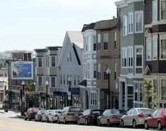 many cars are parked on the side of the street