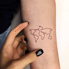 a woman's arm with a world map tattoo on it