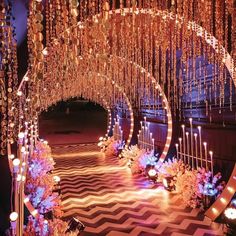 an elaborately decorated stage with candles and chandeliers on the ceiling is lit up