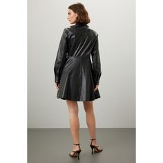 Black faux leather (100% Polyurethane). Full skirt. Long sleeves. Collar. Front button closure. 36" from shoulder to hemline. Imported. Leather Jacket With Button Closure For Night Out, Fitted Faux Leather Jacket With Buttons, Fall Party Leather Jacket With Buttons, Chic Leather Jacket With Buttons For Office, Faux Leather Dress With Button Closure For Night Out, Knee-length Party Outerwear With Button Closure, Party Knee-length Outerwear With Button Closure, Leather Party Outerwear With Button Closure, Party Leather Outerwear With Button Closure