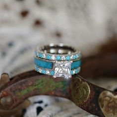 two wedding rings sitting on top of each other in front of a cowgirl's head