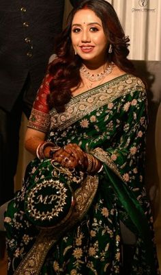 a woman in a green and gold sari