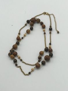 Lia Sophia gold and wood necklace, brown, pearl Vintage Gold Jewelry With Wooden Beads, Vintage Gold Beaded Necklace With Wooden Beads, Elegant Brown Necklace With Gold Beads, Elegant Brown Necklaces With Gold Beads, Brown Beaded Long Necklace Gift, Handmade Gold Wooden Jewelry, Elegant Brown Beaded Chain Necklace, Elegant Brown Long Necklace With Round Beads, Brown Long Beaded Necklace With Wooden Beads