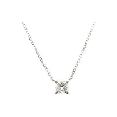 a necklace with a small white diamond in the center on a silver plated chain