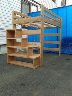 a wooden bunk bed sitting next to a blue tarp