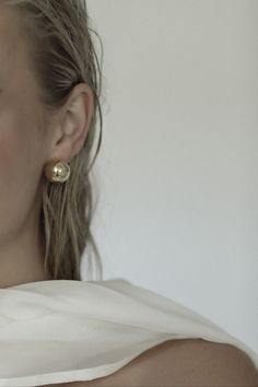 a close up of a person wearing some kind of earring on her left ear