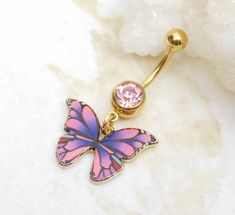 14g gold plated surgical steel belly ring features a pretty pink and purple butterfly charm with gold tone backing. You choose from barbell with matching pink crystal gem or clear crystal gem.  Belly ring measures 1 1/2 inches long total length.  Belly ring is 14g gold plated surgical steel with a 7/16 (11mm) wearable bar length. Charm is lead and nickel free zinc alloy base with high gloss enamel butterfly. For Belly Button Rings: https://www.etsy.com/shop/AllAboutClass?section_id=18474235&ref= Pink Internally Threaded Belly Rings As Gift, Nickel-free Pink Belly Rings As Gift, Pink And Purple Butterfly, Pink Purple Butterfly, Industrial Ring, Gold Belly Ring, Enamel Butterfly, Belly Bar, Navel Jewelry