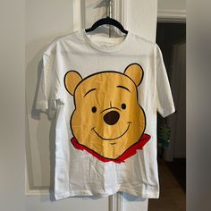 Winnie The Pooh Shirt From Magic Kingdom Size Small Oversized Fit Condition: Brand New With Tags Will Ship Next Day Pooh Shirt, Winnie The Pooh Shirt, Disney Winnie The Pooh, Disney Tops, Magic Kingdom, Shirt Color, Oversized Fits, Winnie The Pooh, Yellow White