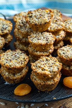 muffins are stacked on top of each other on a plate with orange slices