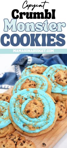 cookies with blue icing and chocolate chips are on a cutting board next to the words crumb monster cookies