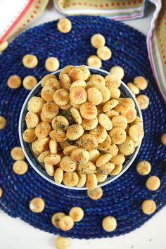 a bowl filled with peanuts sitting on top of a blue plate