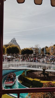 people are riding boats in the water at an amusement park