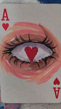 an ace of hearts card with the eye open and red heart painted on it's side